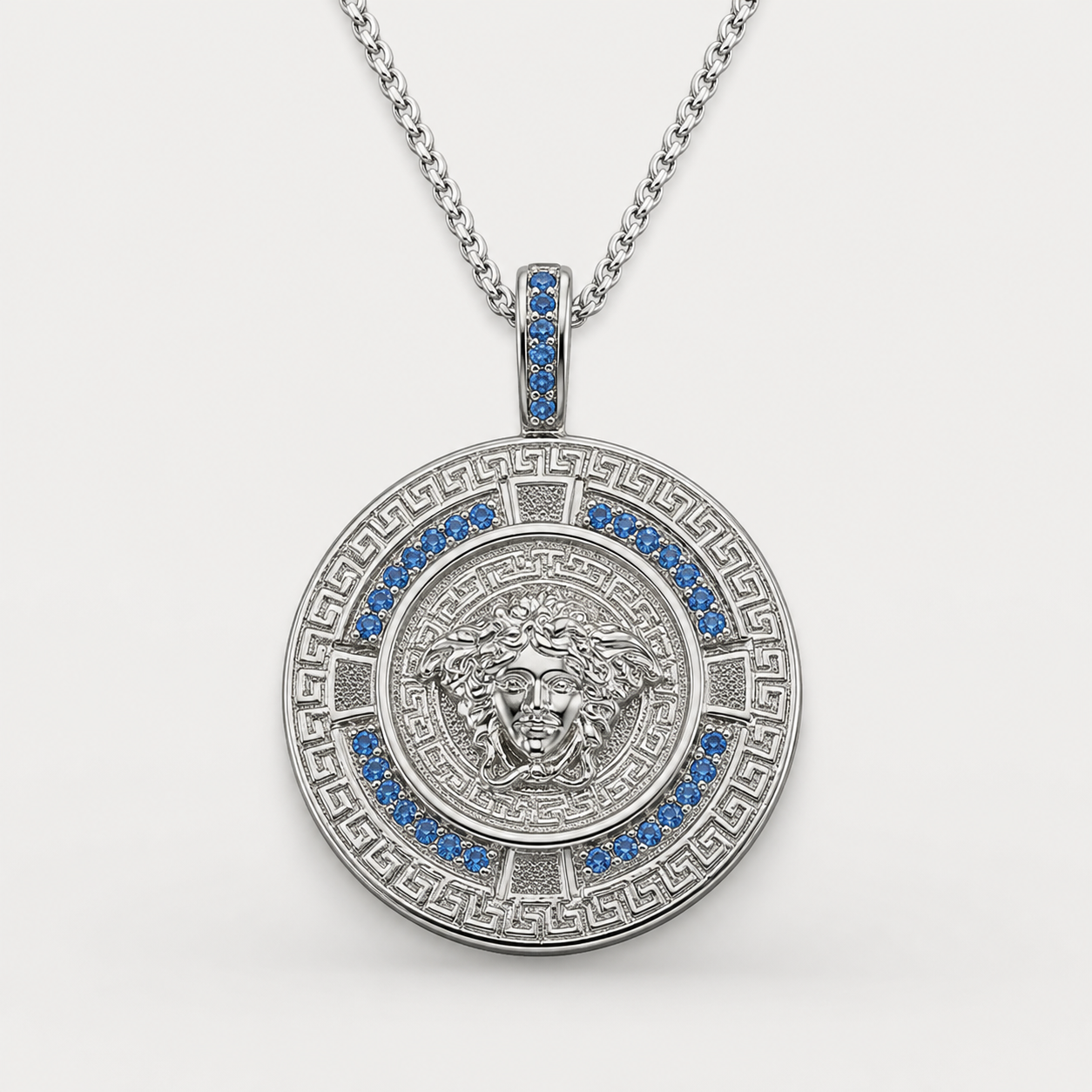 Professional studio product photo of Greek Key Mythology Medusa Big Pendant Baby Blue CZ Stones + Sterling Silver Chain on white background
