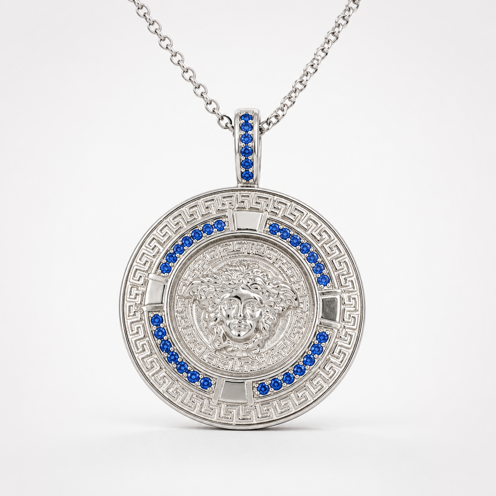 Professional studio product photo of Greek Key Mythology Medusa Pendant Blue CZ Stones + Sterling Silver Chain on white background