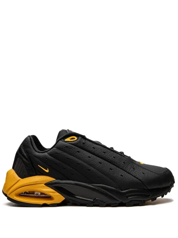 NOCTA x Nike Hot Step Air Terra 'Black University Gold'